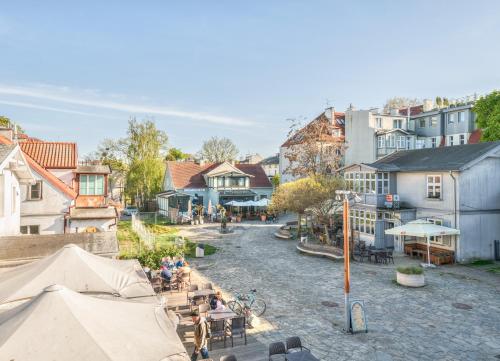 a group of people sitting at tables in a town at Monte Cassino 58 with City View by NorthSide Apartments in Sopot