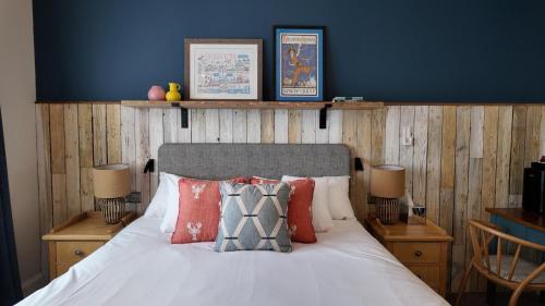 a bedroom with a bed with pillows on it at Downs Hotel in Stanmer