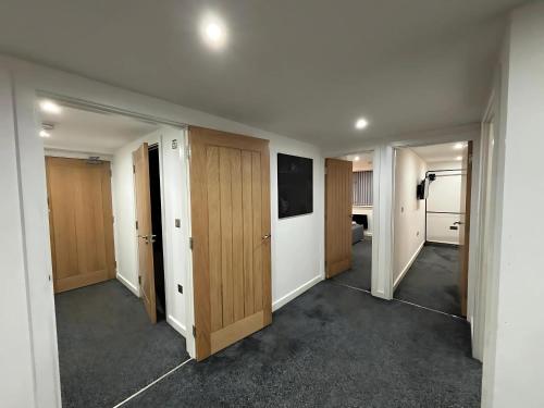 an empty room with wooden doors and a television at CroftCabin in Wolverhampton
