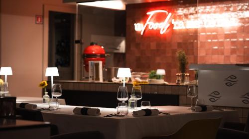 a restaurant with a table with wine glasses on it at Altafiumara Resort & Spa in Villa San Giovanni