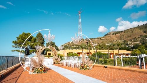 an outdoor wedding with white tables and white chairs at Altafiumara Resort & Spa in Villa San Giovanni
