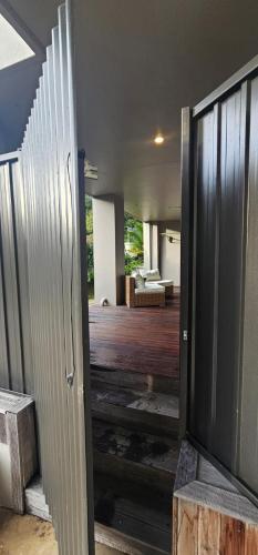 an open door to a living room with a television at C'est La Vie in Tauranga