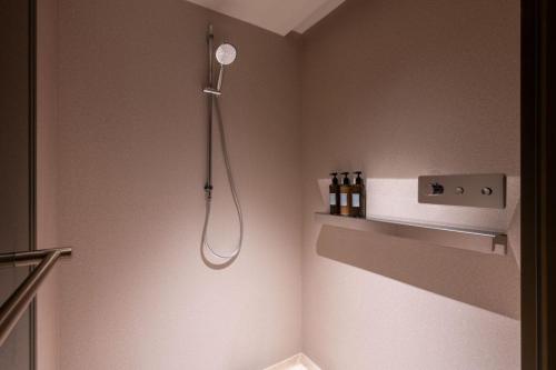 a shower in the corner of a bathroom at Orange Crystal Hotel MixC Shantou East Coast in Shantou