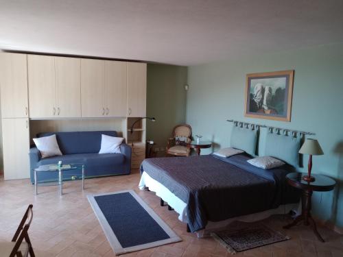 a bedroom with a bed and a couch at Casa dell'Ulivo da Lisa e Alessio008062-LT-0023 in Vallebona
