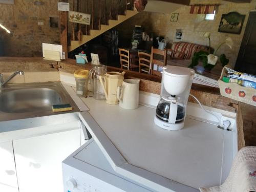 a kitchen counter with a mixer and a sink at Ferme de Montigny (Chambres) in Asnières-en-Bessin