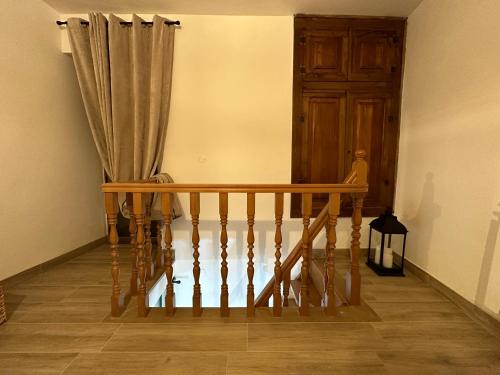a staircase with a wooden railing and a wooden door at Mariella Vernile in Civitella Roveto
