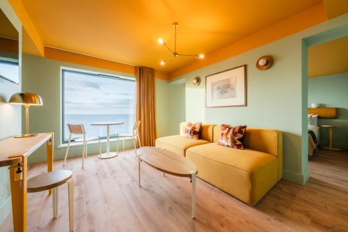 a living room with a couch and a table at SeaSpace in Newquay