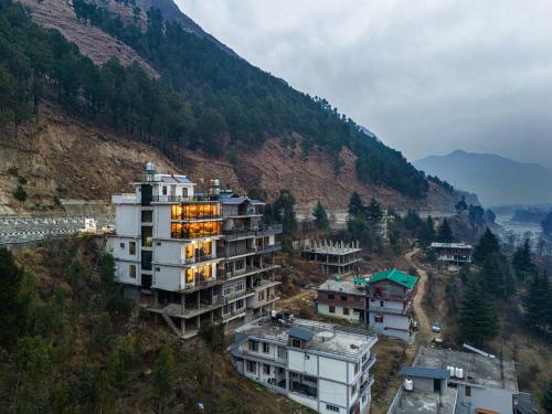 a building on the side of a mountain at Palm Villa, Kullu in Shamshi