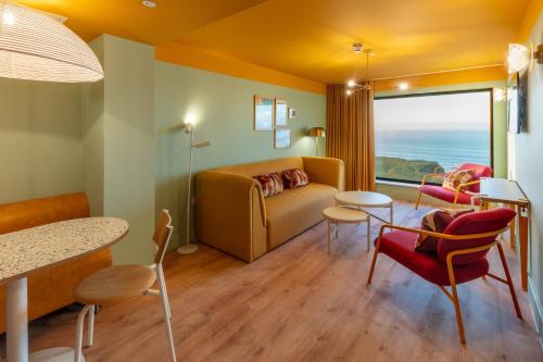 a living room with a couch and a table at SeaSpace in Newquay