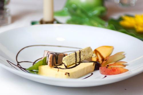 a white plate of food on a table at Hotel Rotwand in Laives