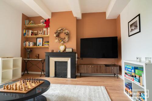 - un salon avec un échiquier et une cheminée dans l'établissement Superbe appartement de 91m2 au centre de Vias, à Vias