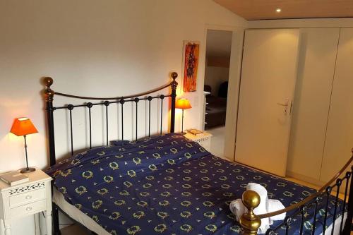 a bedroom with a bed with a blue comforter at Via Valla - Spacious Open-plan and Peaceful Chalet in Salums in Laax