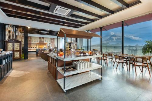 a restaurant with a buffet with tables and chairs at Mustika Yogyakarta Resort and Spa in Yogyakarta