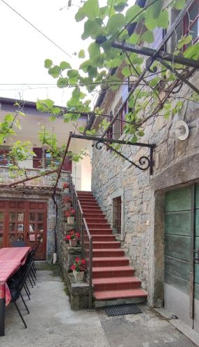 a set of stairs leading up to a building with a table at Bordon wines, estate with accommodation in Dekani