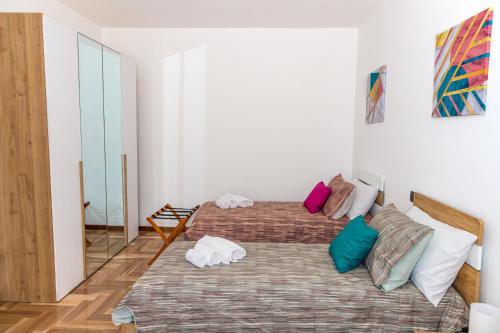 a bedroom with two beds and a mirror at Casa Vacanza Anna Maria in Clusane sul Lago