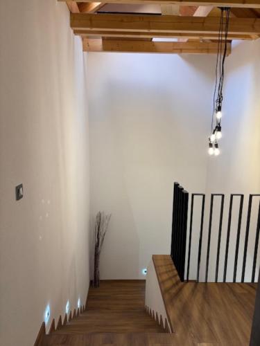 a room with a white wall and a wooden floor at Apartmány Camping Český les in Lesná
