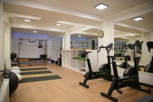 a gym with treadmills and ellipticals in a room at The Local House Alaçatı in Alacati