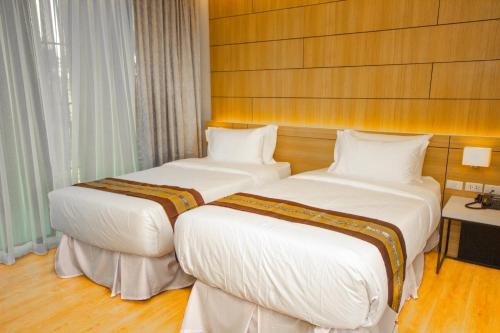 Letto o letti in una camera di The Grand Chaiyapruek Nimman Chiangmai