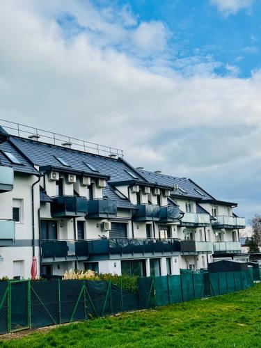 an apartment building with solar panels on it at Marót Apartman in Keszthely