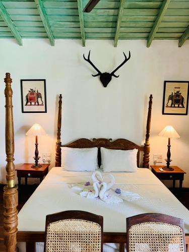 a bedroom with a bed with a clock on the wall at Villa Seven Faces-Luxury Escape,Stunning Views with Private pool for a Couple or family! in Galle
