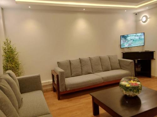 a living room with a couch and a table at Lukenya Alkebu Resort in Nairobi
