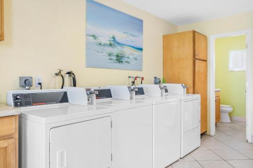a kitchen with a row of white cabinets at Palm Cay 5 in Holmes Beach