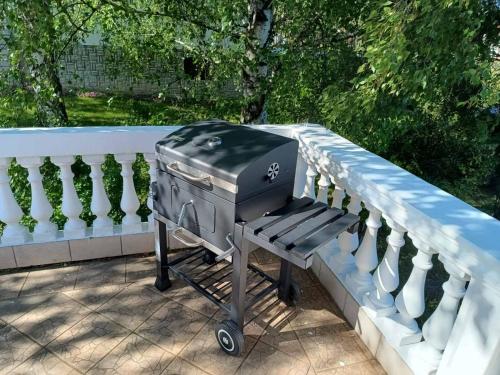 a grill sitting on a fence on a patio at Cozy Place in Pavi°evac