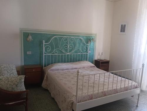 a bedroom with a bed with a green headboard at BeB Angelini dal 1911 in Lucca