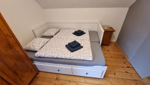 a bed with two pillows on it in a room at Vila Koman Jezersko in Zgornje Jezersko