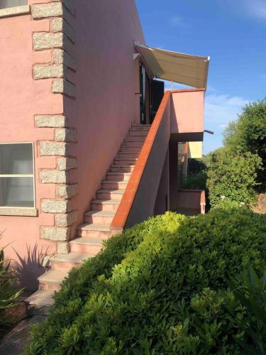 a set of stairs leading up to a house at Grandpà apartment in residence with swimming pool in Badesi