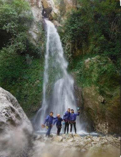 a group of people standing in front of a waterfall at Casa vacanza P&G in Laino Castello