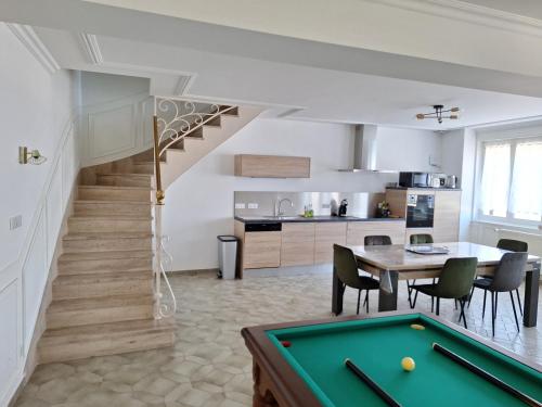 a kitchen and dining room with a pool table at 7Cépages in Vertus