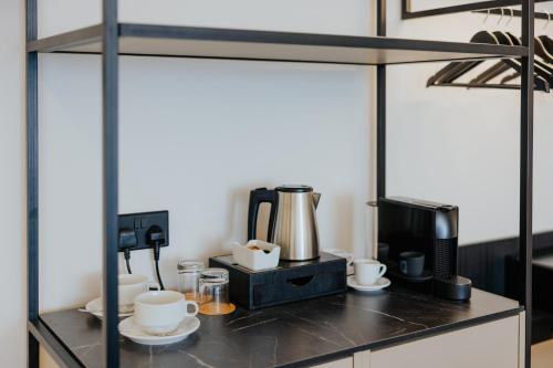a coffee station with a coffee maker and a coffee pot at Odysseia Hotel Kapetanios in Limassol