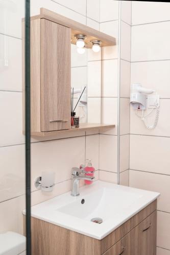 a bathroom with a sink and a mirror at Argo Rooms-Papadakis in Kissamos