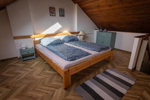 a bedroom with a wooden bed in a attic at Varady's large apartment with private parking in Košice