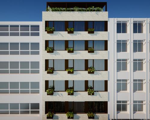 an apartment building with potted plants on the facade at Eternity Athens -Opening 2025- in Athens