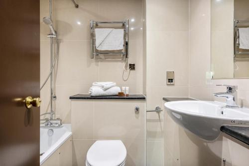 a bathroom with a toilet and a sink at Dragonfly Hotel Bury St Edmunds in Bury Saint Edmunds