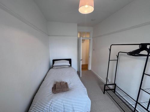 a small bedroom with a bed in a room at Helensburgh Central Apartment - Macaulay Letting in Helensburgh