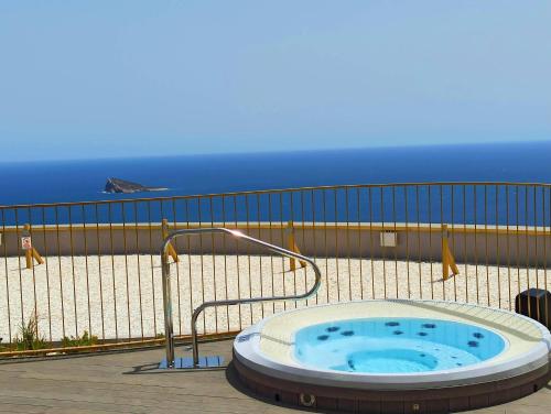 a hot tub on a balcony with the ocean in the background at Intempo Sea Views by Agencia Poniente in Benidorm