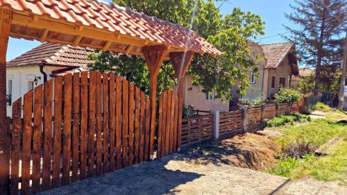 a wooden fence in front of a house at Jovački San in Donji Jovac