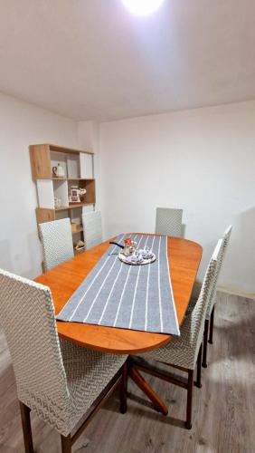 a dining room with a wooden table and chairs at Jovački San in Donji Jovac