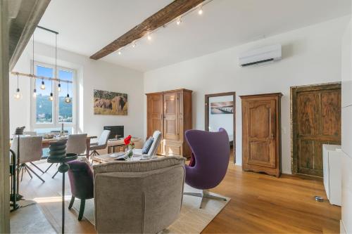 a living room with a table with a laptop on it at Mica Aurea Morcote - Happy Rentals in Morcote