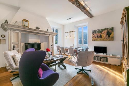 a living room with a table and chairs at Mica Aurea Morcote - Happy Rentals in Morcote