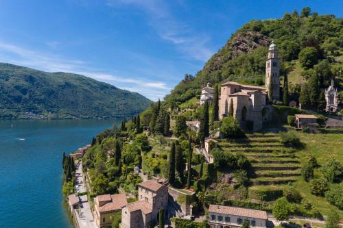 an estate on a hill next to the water at Mica Aurea Morcote - Happy Rentals in Morcote