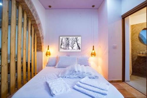 a bedroom with a white bed with towels on it at Molise Garden Apartments Renato in Boiano