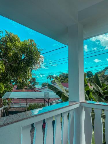 a balcony with a view of the ocean at Divers Lodge Guest House in Beau Vallon