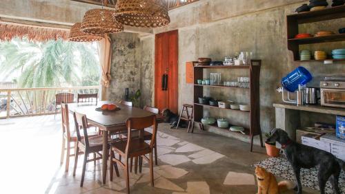 a dining room with a table and a dog at Baia Nest TURINGAN Loft, Self-Service Breakfast, Near the Beach, Pet Friendly with a Fee in Gubat