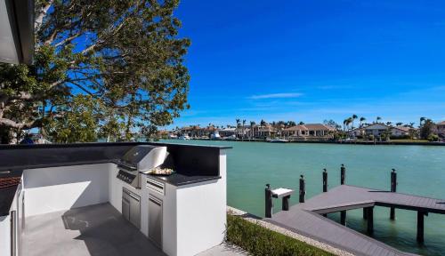 a kitchen with a grill next to a body of water at Meridian Blu in Marco Island