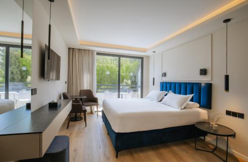 a hotel room with a bed and a desk at Odysseia Hotel Kapetanios in Limassol