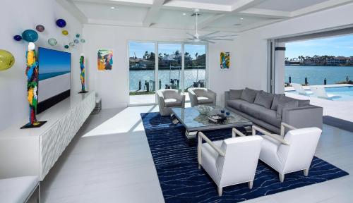 a living room with a couch and a table and chairs at Meridian Blu in Marco Island